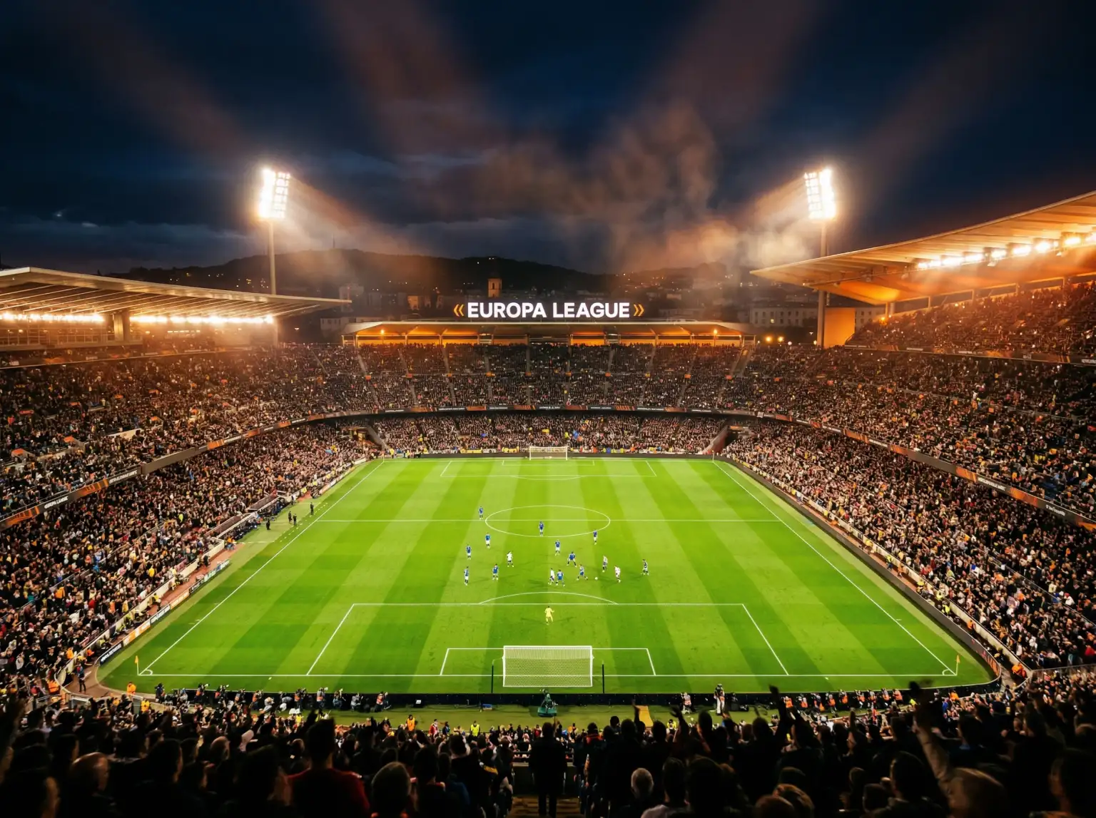 Estadio de fútbol europeo iluminado durante un partido nocturno de Europa League